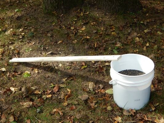 Diy chipmunk catcher. All i used was a 5 gallon bucket, pc of wood